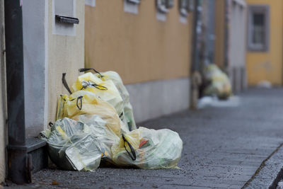 Garbage on street against wall