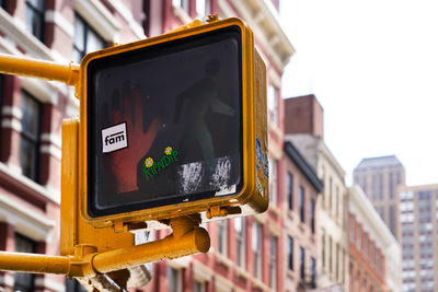 Low angle view of road sign against sky