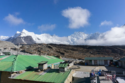 Panoramic view of buildings and mountains against sky