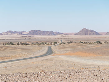 Scenic view of desert against clear sky