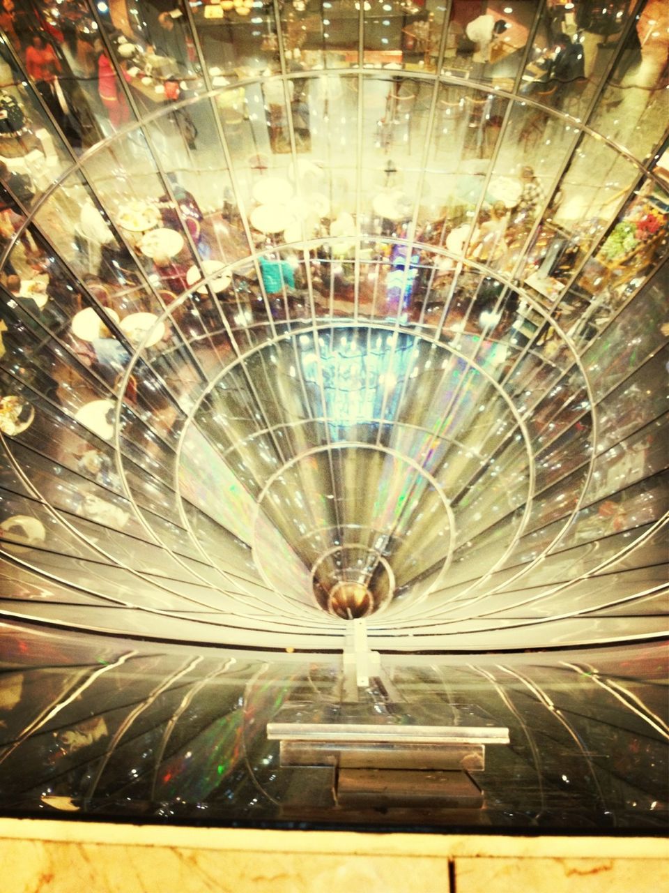 indoors, ceiling, illuminated, lighting equipment, pattern, full frame, backgrounds, low angle view, shopping mall, high angle view, hanging, glass - material, design, modern, no people, directly below, reflection, interior, transparent, electric light