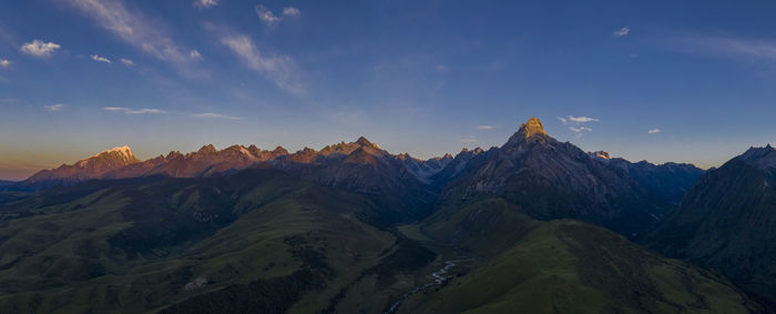 Panoramic view of snowcapped mountains against sky