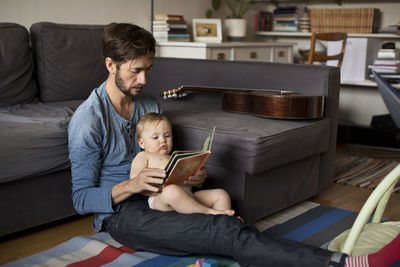 Father reading book to baby