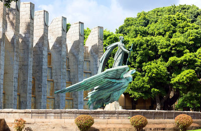 Low angle view of statue against trees