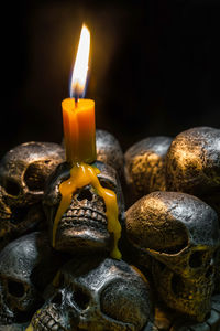 Close-up of lit candle in the dark