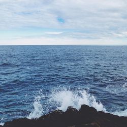 Scenic view of sea against cloudy sky