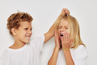 Sibling fighting against white background