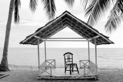 Lifeguard hut on beach against sky