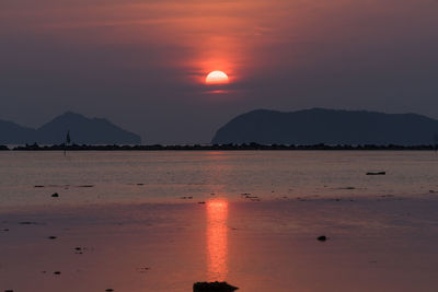 Scenic view of sea against orange sky