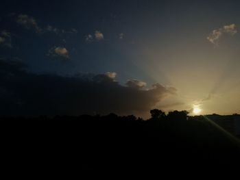 Silhouette trees against sky during sunset