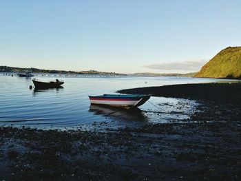 Boat moored on sea against sky