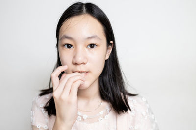 Portrait of smiling woman against white background