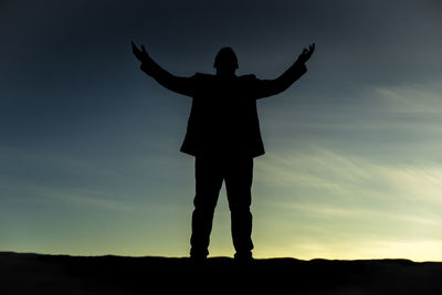 Silhouette woman standing against sky