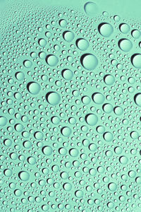 Detail and close up of condensation drops of pink water on surface. texture background decoration.