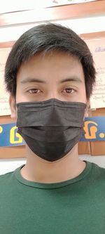 Close-up portrait of young man covering face
