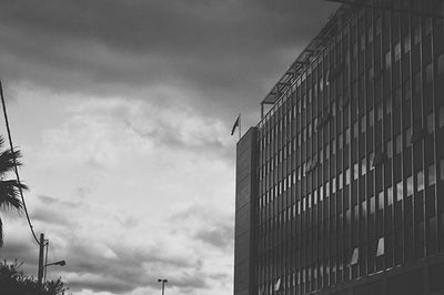 Low angle view of buildings against cloudy sky