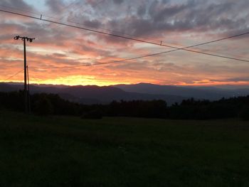 Scenic view of silhouette field against sky during sunset