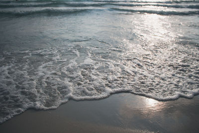 High angle view of waves rushing towards shore