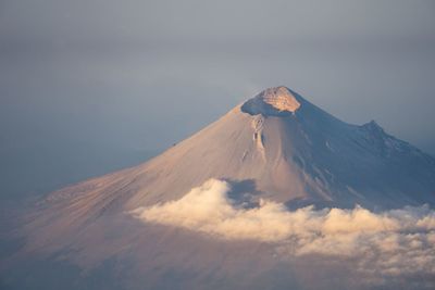 Scenic view of snowcapped mountain against cloudy sky