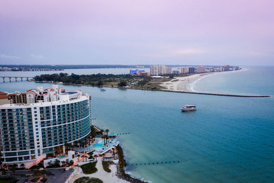High angle view of buildings by sea against sky