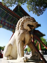 Low angle view of statue against temple