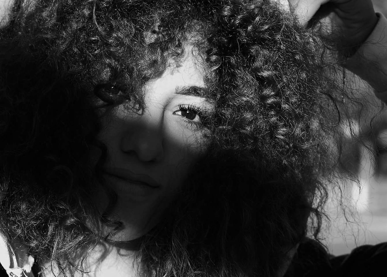 CLOSE-UP PORTRAIT OF YOUNG WOMAN WITH HAIR