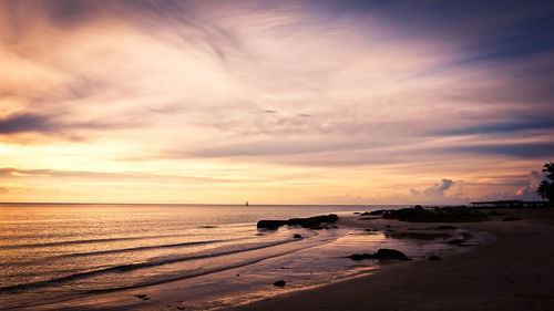 Scenic view of beach against sky during sunset