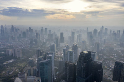 High angle view of modern buildings in city against sky