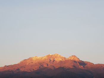 Scenic view of snowcapped mountains against clear sky