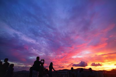 Silhouette people against sky during sunset