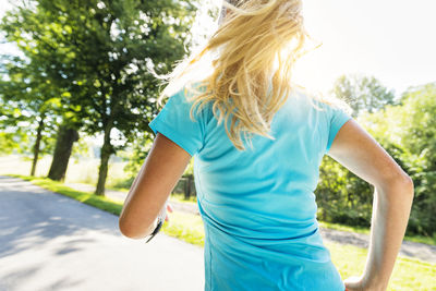 Woman jogging on country road