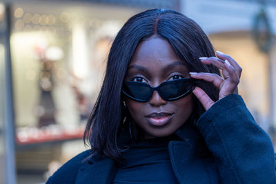 Portrait of young woman wearing sunglasses