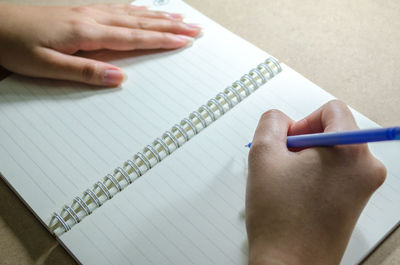 Close-up of person hand holding book