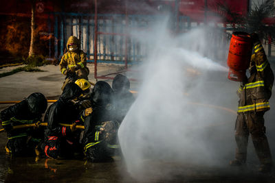 Firefighter spraying water on fire