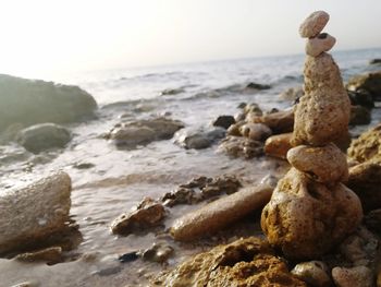 Rocks on beach against sky