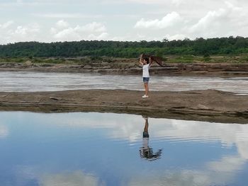 Man standing on beach against sky