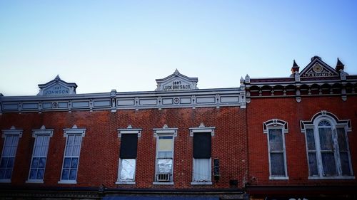 Low angle view of building against clear blue sky