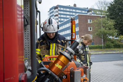 Firefighters preparing near fire engine