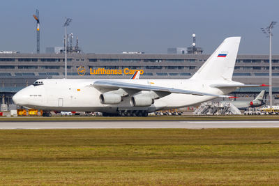Airplane on airport runway against sky