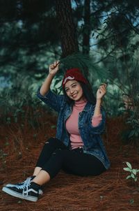 Portrait of a smiling young woman sitting outdoors
