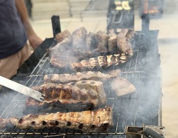 Man preparing food on barbecue grill
