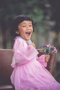 Close-up of girl with pink flower