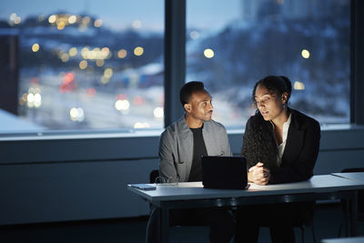 Colleagues working late in office