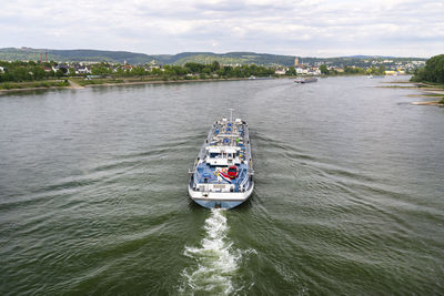 A large tanker ship sailing in germany on the rhine river. transportation of oil, gas and gasoline.