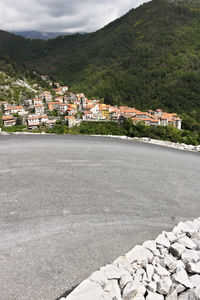 View of town by mountain against sky