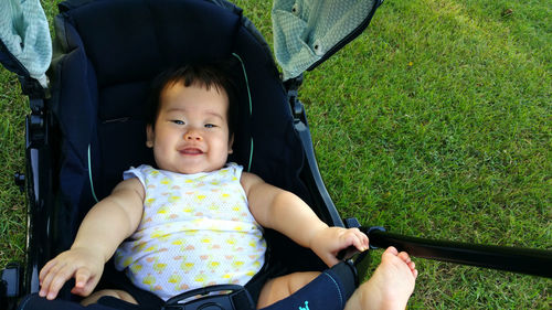 Portrait of cute girl sitting on grass