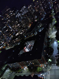 High angle view of illuminated modern buildings in city at night