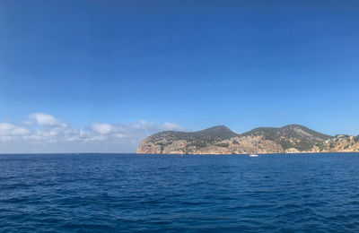 Scenic view of sea against blue sky