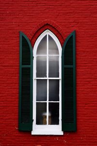 Close-up of window on red brick wall