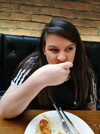 Portrait of young woman eating food
